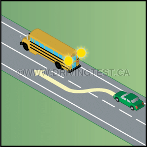 Test 3 - If a school bus has flashing yellow lights, what should you do?